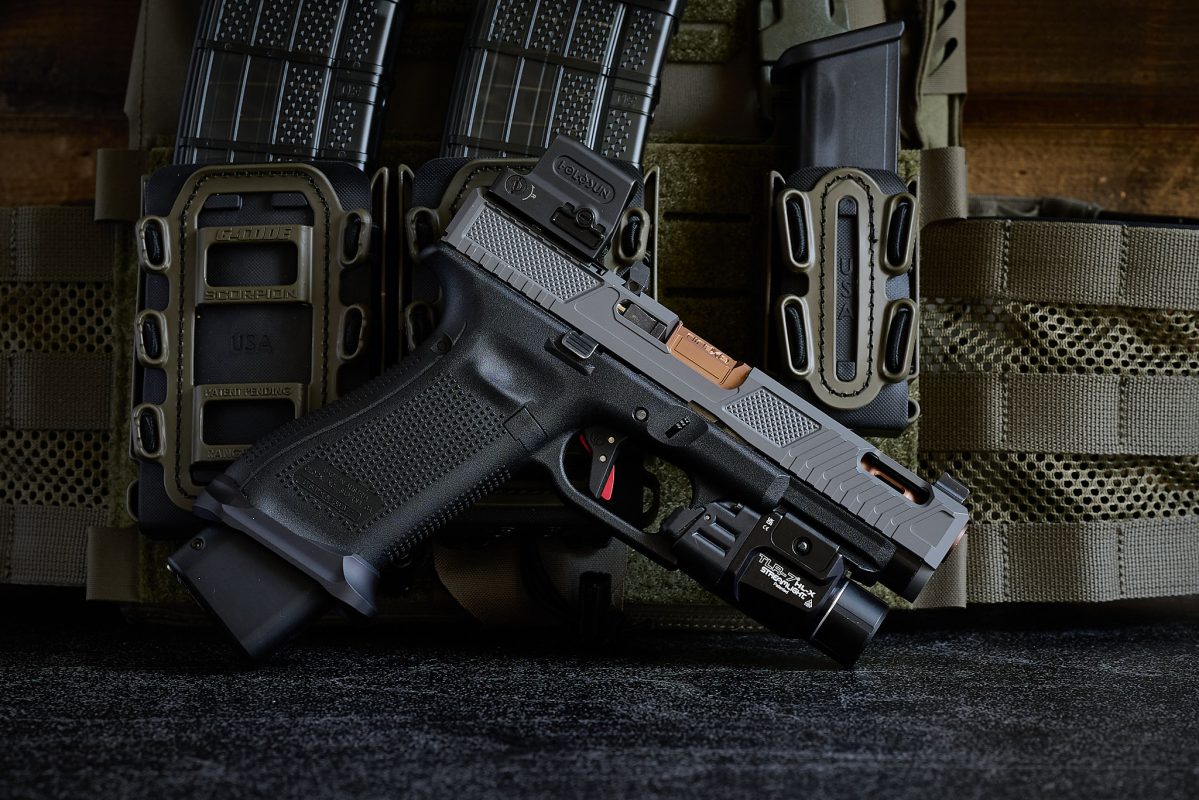 Custom Glock 17 Gen 5 with gray Vapor slide, copper barrel, optic, weapon light, and full-size frame.